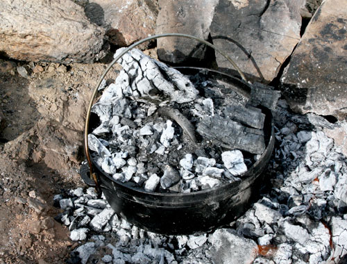 Why do some people put coals in the lid of a Dutch oven whilst